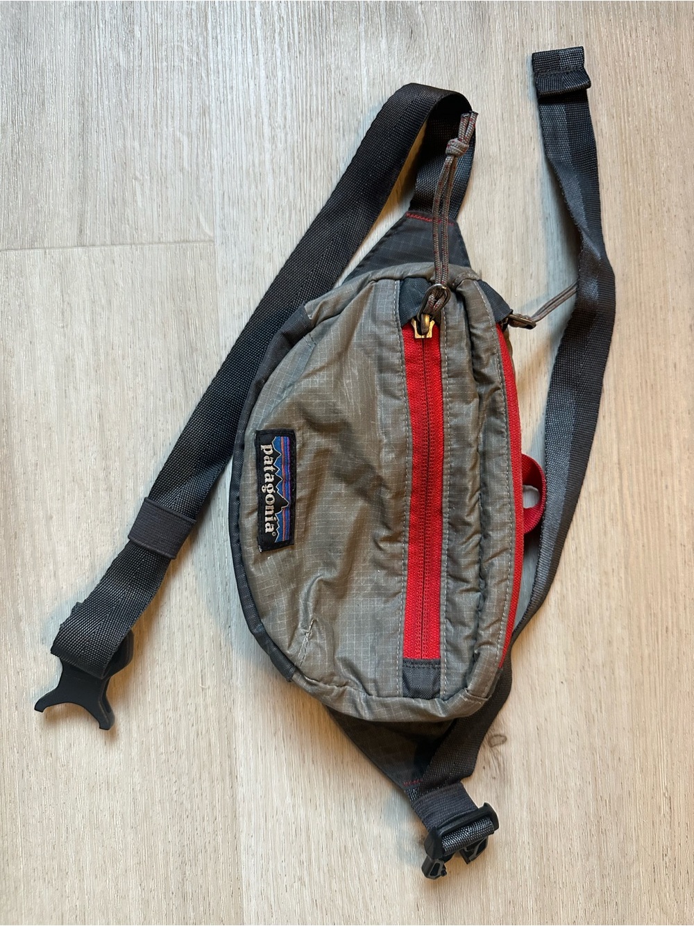 Patagonia Gray Sling Belt Bag with Red Zip Accents